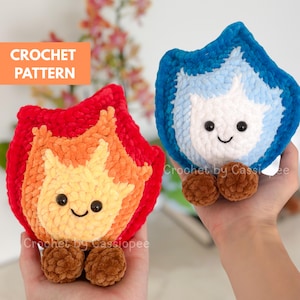 May include: Two plush crochet flame-shaped toys. One is red, orange, and yellow, the other is blue and white. Each has a smiling face with black eyes and brown pom-pom feet. The text "CROCHET PATTERN" is in an orange box.