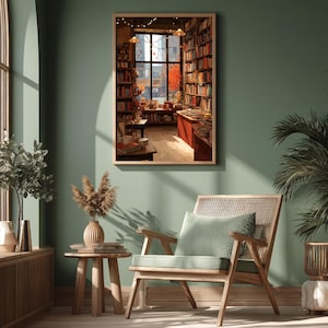 A framed illustration of a bookstore with autumn trees outside the window, centered on a dark green wall above a wooden chair and plant.