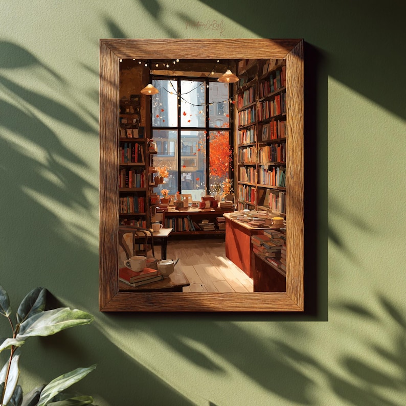 A framed illustration of a cozy bookstore with a large window looking out onto autumn trees, hanging on a light green wall with plant shadows.