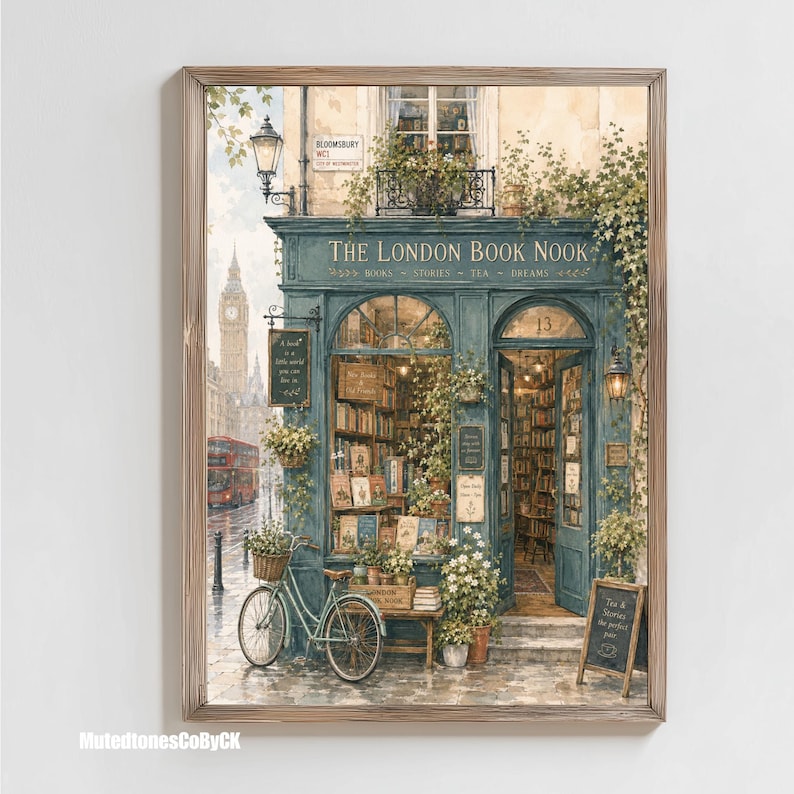 A framed watercolor illustration of a blue-green storefront with "THE LONDON BOOK NOOK" above the door, a bicycle parked outside, and Big Ben in the background, with a watermark in the bottom left corner.