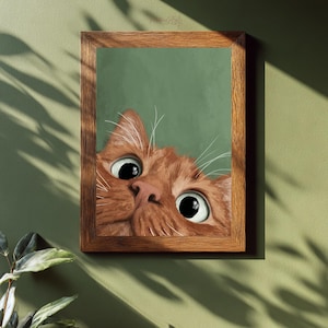 May include: A framed art print featuring a curious orange tabby cat peeking out from behind a green background. The cat's large, expressive eyes and pink nose are the focal point, set within a wooden frame.