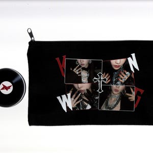 May include: Black zippered pouch with a collage of four images and the word "WONG" in red and white. A black vinyl record with a red star logo is to the left.