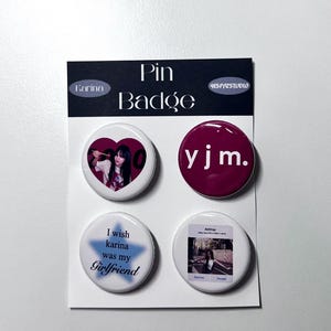 May include: Set of four pin badges featuring a heart with a photo of a woman, a red badge with the text "yjm.", a blue star with the text "I wish karina was my Girlfriend", and a photo of a woman with the text "AirDrop".