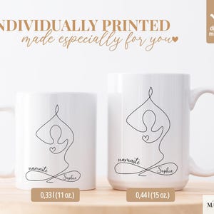 May include: Two white ceramic mugs with a black line drawing of a yoga pose. The mugs have the words "namaste" and "Sophie" written on them. The text "INDIVIDUALLY PRINTED made especially for you" is above the mugs. The mugs are 11 oz and 15 oz.