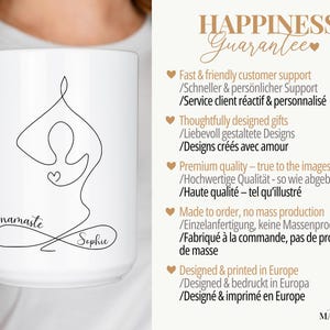 May include: White ceramic mug featuring a black line drawing of a person in a yoga pose with the word "namaste" and a name. The mug has a large handle and is held by a person.
