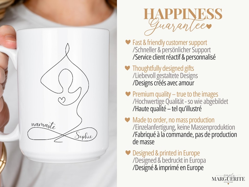 May include: White ceramic mug featuring a black line drawing of a person in a yoga pose with the word "namaste" and a name. The mug has a large handle and is held by a person.