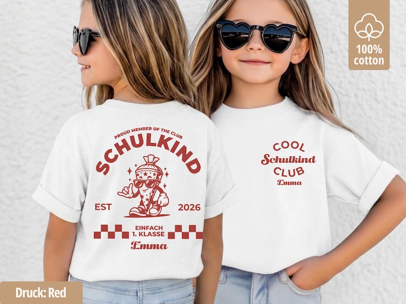 May include: A white t-shirt featuring red graphic prints. The back displays a cartoon character in a cone, the text "PROUD MEMBER OF THE CLUB SCHULKIND EST 2026 EINFACH 1. KLASSE" and the name "Emma". The front features "COOL Schulkind CLUB Emma".