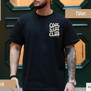 May include: Black t-shirt with the text "COOL DADS CLUB" in a retro font. The shirt is made of 100% cotton. The shirt is a classic crew neck style. The shirt is a solid black color.