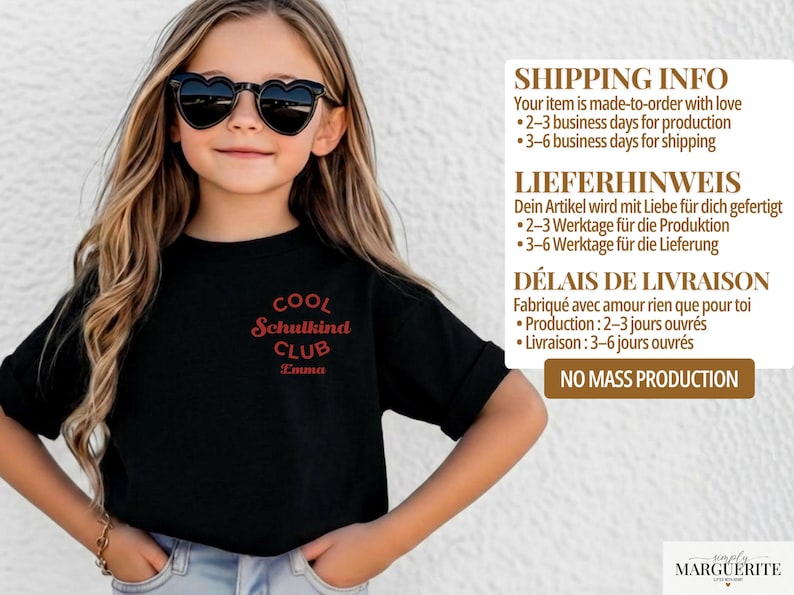 May include: A black t-shirt featuring a red circular graphic on the chest with the text COOL SCHULKIND CLUB and the name Emma printed below. The shirt has short sleeves and a crew neckline, worn with heart-shaped sunglasses.
