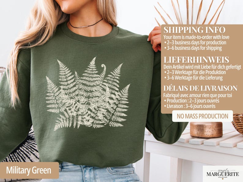 Puede incluir: Sudadera verde militar con un dise&ntilde;o de helecho blanco. La parte superior de manga larga tiene cuello redondo. El texto "Military Green" est&aacute; en la parte inferior de la imagen. La sudadera es de material suave.