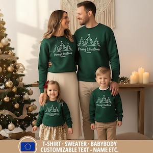 May include: A family of four wearing matching dark green sweatshirts with a white Christmas tree design and the text "Merry Christmas". The sweatshirts are paired with neutral-colored bottoms. A Christmas tree is in the background.