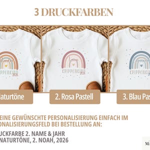 May include: Three white t-shirts featuring a rainbow graphic with a small heart in the center and the text KRIPPENKIND 2026. The designs are available in three color palettes: natural tones, pastel pink, and pastel blue, each with a name printed.