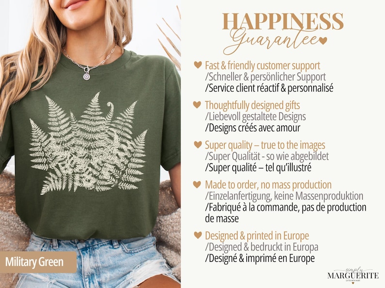 Puede incluir: Camiseta verde militar con un dise&ntilde;o de helecho crema. La camiseta tiene cuello redondo y mangas cortas. El texto "HAPPINESS Guarantee" es visible en la imagen.
