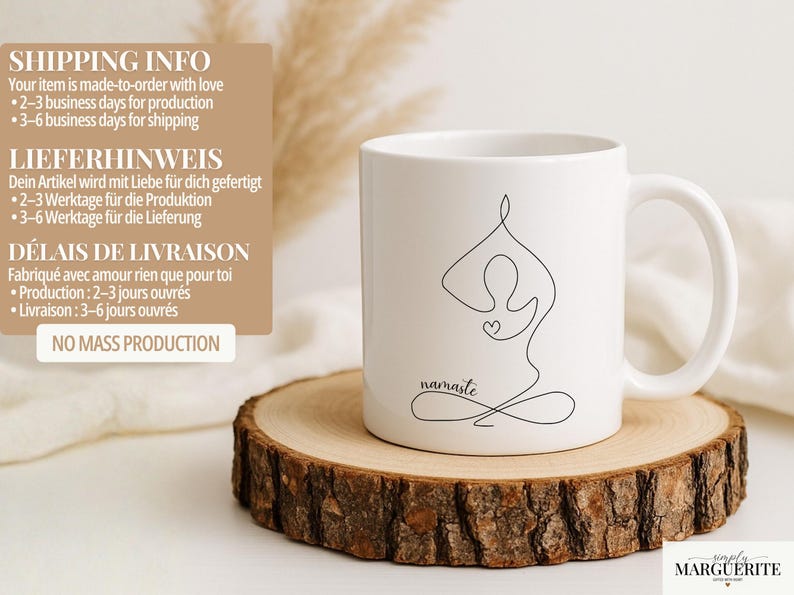 May include: White ceramic mug with a black line drawing of a person in a yoga pose, with the word "namaste" below. The mug is on a wooden slice. The mug has a curved handle.