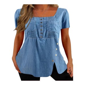 May include: Light blue denim top with a square neckline, short sleeves, and button details. The top features pleats and two small pockets on the chest. Buttons run down the center and along the side slit. A casual, everyday garment.