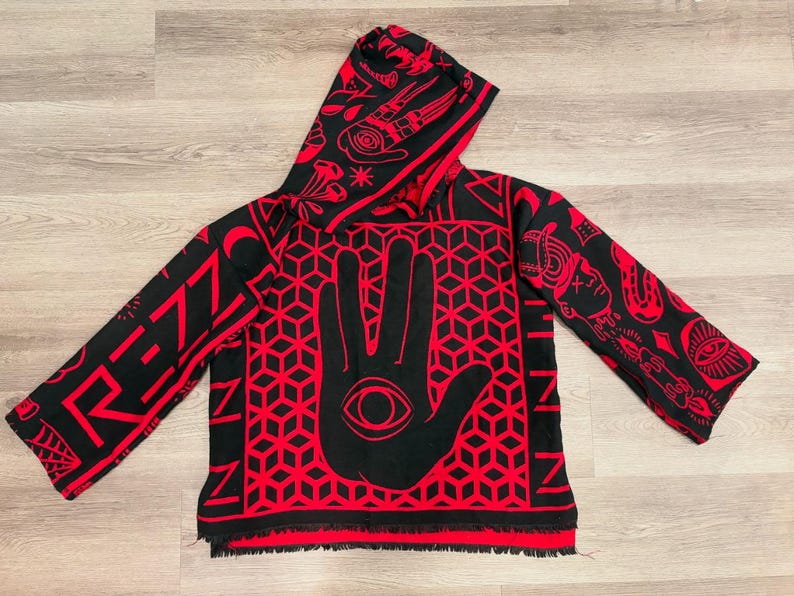 May include: Black and red hooded sweatshirt with a geometric hand and eye design. The sleeves and hood feature additional red patterns and the word "RENZ" in red. The bottom hem has a fringe.