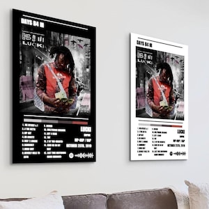 May include: Two framed posters featuring the album art for "DAYS B4 IN" by Lucki. The artwork shows a person holding money in front of a blurred city background. The poster includes a tracklist and the date October 25th, 2019.
