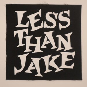 May include: Black and white patch with the text "Less Than Jake" in a stylized font.