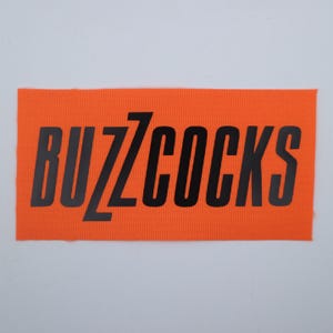 Buzzcocks - Logo Patch Orange/Black