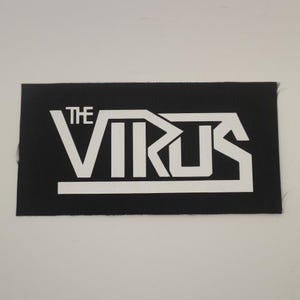 May include: Black and white embroidered patch with the text "THE VIRUS" in a bold, stylized font.
