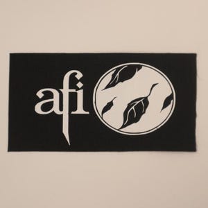 May include: Black and white embroidered patch with the text "afi" and a stylized image of leaves in a circle.