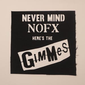 May include: Black fabric patch with white text that reads "Never Mind NOFX Here's The GimmeS".