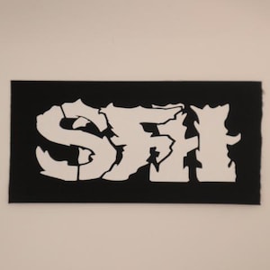 May include: Black patch with white lettering that reads "S.F.H."