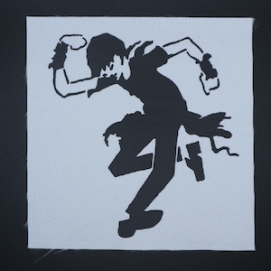 May include: A black and white patch featuring a silhouette of a person throwing an object. The figure is in motion, with one arm raised and the other extended. The patch is square and has a light blue background.