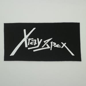 May include: A black rectangular patch with the white text "Xray Apex" in a stylized, handwritten font. The patch has a textured surface and is likely made of fabric.
