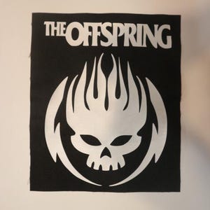 May include: Black and white patch with the band name "The Offspring" and a skull with flames logo.