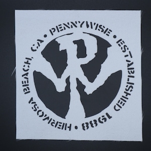 May include: Square, light gray fabric patch with a black circular design. The design features the word "PENNYWISE" arched across the top, "ESTABLISHED" on the right, "HERMOSA BEACH, CA" on the left, and "1988" at the bottom. A stylized "P" is in the center.