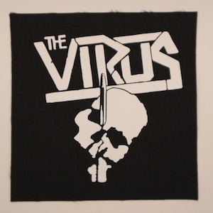 May include: A square black fabric patch featuring a white screen-printed graphic. The design displays the text THE VIRUS in a bold, blocky font above a silhouette of a skull being pierced by a vertical bullet shape in the center of the image.