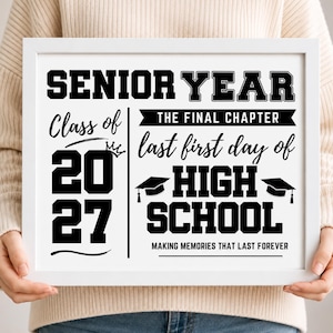 May include: A white framed sign featuring black text that reads SENIOR YEAR, Class of 2027, THE FINAL CHAPTER, last first day of HIGH SCHOOL, and MAKING MEMORIES THAT LAST FOREVER, accompanied by graphics of a small crown and two graduation caps.