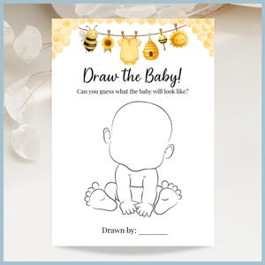 May include: A white baby shower game card with the text "Draw the Baby!" and a blank baby outline. The top of the card features watercolor illustrations of a bee, sunflower, baby clothes, a beehive, and a sun. The bottom of the card has a line for "Drawn by:"