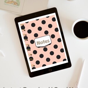May include: A digital tablet displaying a spiral-bound notebook cover design with a light peach background and a repeating pattern of solid black polka dots. A central white rectangular label with a stitched border features the word Notes in gray.