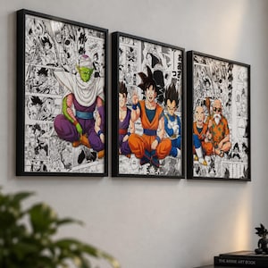 May include: Three rectangular black-framed wall art prints featuring colourful anime characters layered over black and white manga panels. The artwork displays various figures in dynamic poses, including a green character and orange-clad fighters.