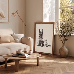 May include: A black and white illustration of a German Shepherd dog and a cat sitting side by side. The illustration is framed and hanging on a wall in a living room.