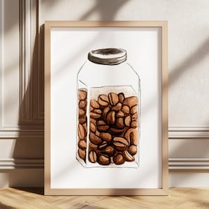 May include: Watercolor print of a glass jar filled with coffee beans. The jar has a gray lid and is set against a white background. The artwork is framed in a light brown wooden frame, adding a touch of warmth to the piece.