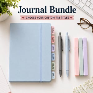 May include: A light blue journal with an elastic closure and six labelled tabs reading SCHEDULE, EXAMS, NOTES, CLASSES, HOMEWORK, and GOALS. The set includes a dark grey pen, a light blue pen, and three rectangular highlighters in pink, green, and purple.