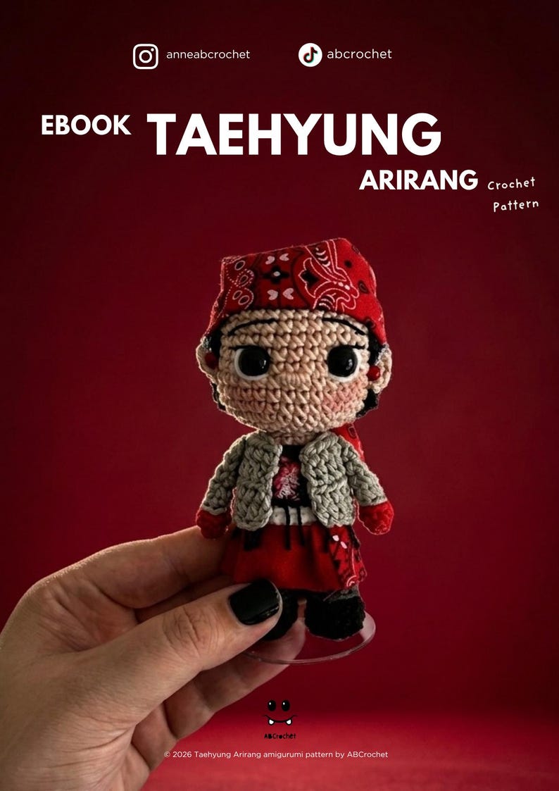 May include: A crochet amigurumi doll featuring a red bandana with a white paisley pattern, a light gray textured jacket, and a red skirt. The doll has large black eyes and is presented as an EBOOK TAEHYUNG ARIRANG Crochet Pattern.