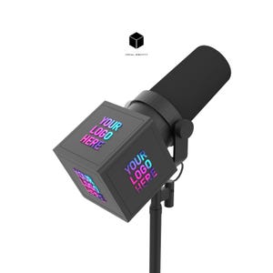 May include: A black microphone with a cylindrical body and a square head. The square head has the text "YOUR LOGO HERE" in a gradient of pink, blue, and purple. The microphone is mounted on a black stand. The Vocal Identity logo is in the top center.