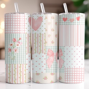 May include: Three stainless steel tumblers with clear straws. Each tumbler has a patchwork design with pink and green patterns, including hearts, bows, flowers, and stripes. The tumblers are designed for cold drinks.