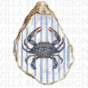 May include: A watercolor illustration of an oyster shell with a gold-painted edge, featuring a blue and white vertical striped background and a central blue crab with a detailed leopard print pattern on its shell and legs, centered on a white background.