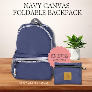 May include: Navy blue canvas foldable backpack with white trim and the text "Alice in Wonderland." Includes a matching pouch. The backpack measures 42 cm wide, 28.5 cm high, and 11 cm deep. It is waterproof and machine washable.