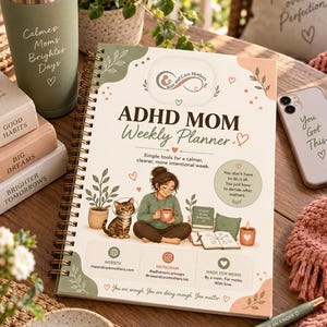 May include: A spiral-bound ADHD MOM Weekly Planner with a cream cover featuring an illustration of a person holding a mug next to a cat, a potted plant, and books. The text reads ADHD MOM Weekly Planner, Simple tools for a calmer, clearer, more intentional week, and You don't have to do it all. You just have to decide what matters.