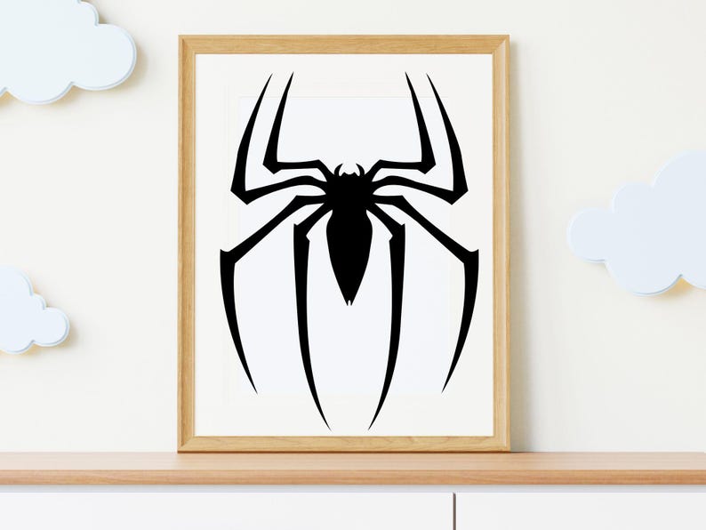 May include: Framed art print featuring a black spider silhouette on a white background. The spider design has eight legs and a detailed body. The artwork is displayed in a light brown wooden frame, suitable for wall decor.