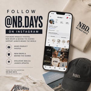 May include: A smartphone displaying an Instagram profile for nb.days, a beige sweatshirt with NBD. NO BAD DAYS text, and a black baseball cap with NBD. embroidery. Text on the left reads FOLLOW @NB.DAYS ON INSTAGRAM and lists content categories.
