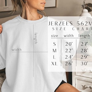 May include: A white long-sleeve sweatshirt with a size chart overlay labeled JERZEES 562MR. The chart lists sizes S, M, L, and XL with corresponding width and length measurements in inches, ranging from 20 to 26 inches wide and 27 to 30 inches long.