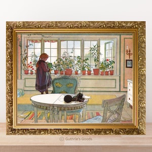 May include: A framed print of a vintage interior scene. A young person waters plants in a sunlit room with a round table, chairs, and a window filled with potted plants. The frame is ornate gold.