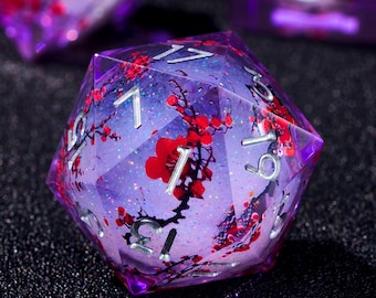 May include: A purple, twenty-sided die with silver numbering and a floral design featuring red blossoms. The die has a glittery, translucent appearance, with a dark background.